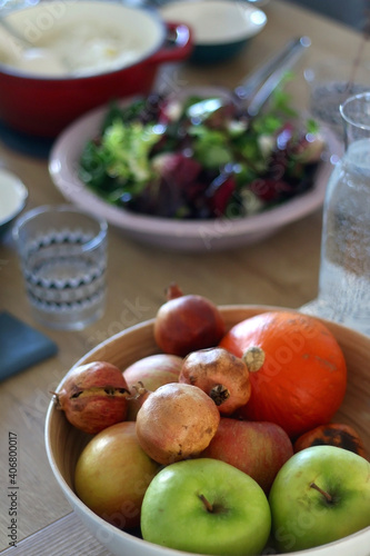 Bowl with various fruit on the table. Selective focus.