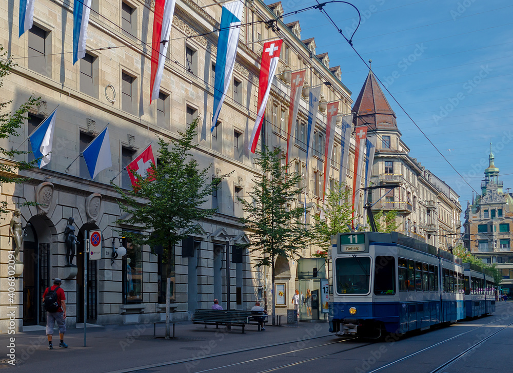 A blue tram traveling along an iconic shopping street in Zurich, Switerland