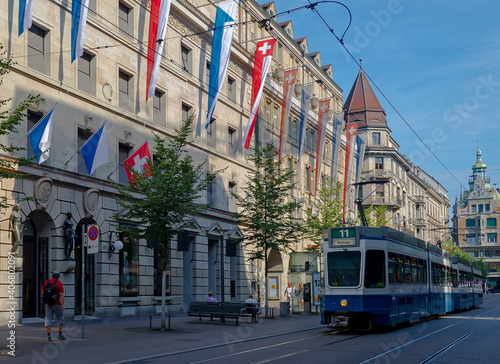 A blue tram traveling along an iconic shopping street in Zurich, Switerland