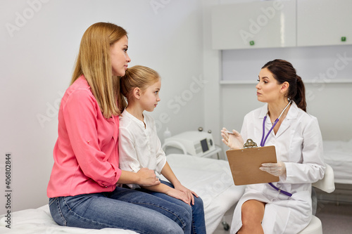 doctor pediatrician talking with child girl patient came with mom, consulting. children medical care, health, help, medicine concept