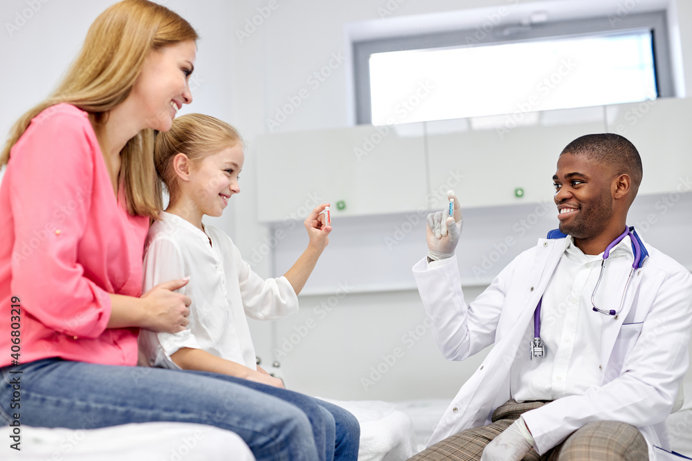 black male doctor have a nice talk with kid girl, showing colourful modern capsules to her, he disposes, work with children in hospital black male doctor have a nice talk with kid girl, showing colourful modern capsules to her, he disposes, work with children in hospital