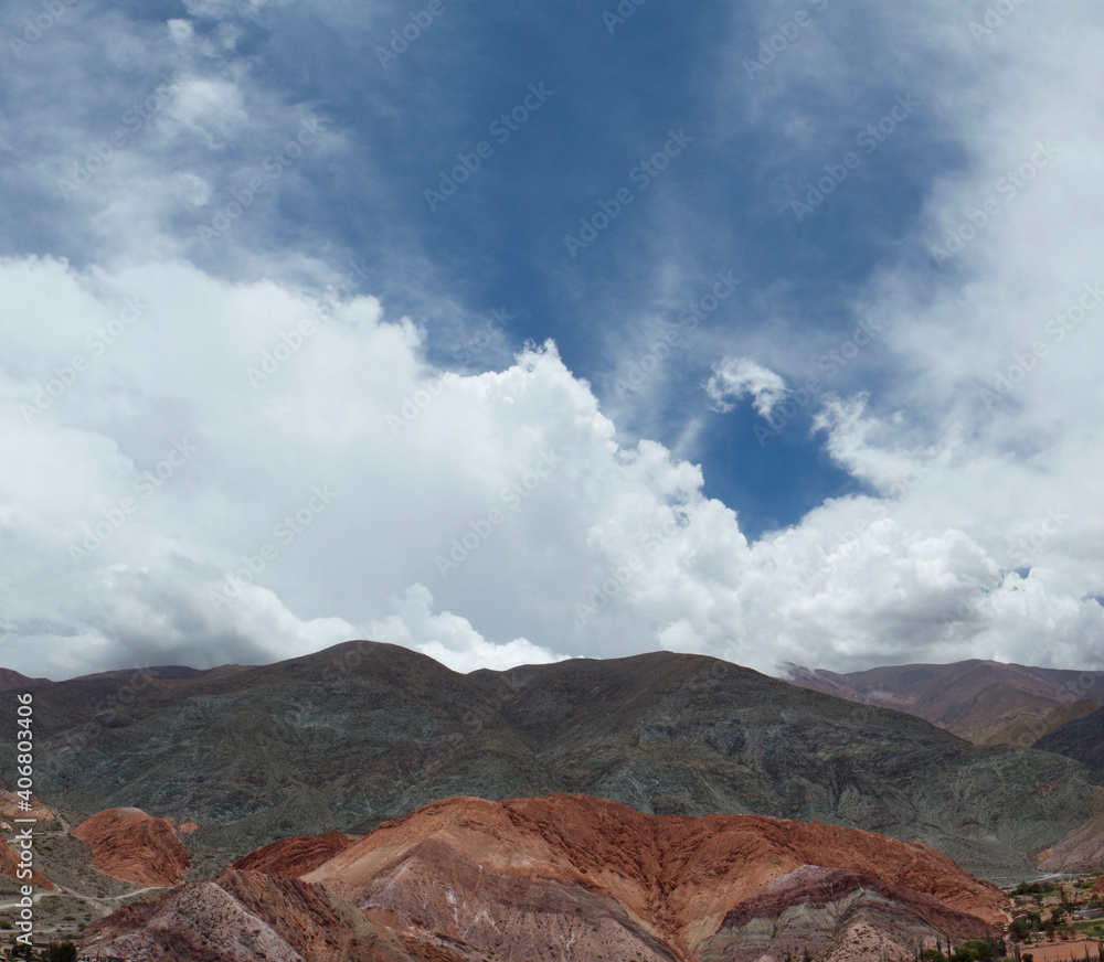 Aerial view of the popular Seven Color Hill in Purmamarca, Jujuy, Argentina. The beautiful hill texture and different mineral colors under a majestic sky.