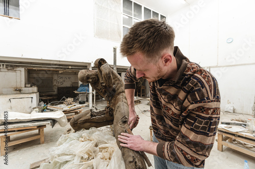 Sculptor in his workshop creating a sculpture
