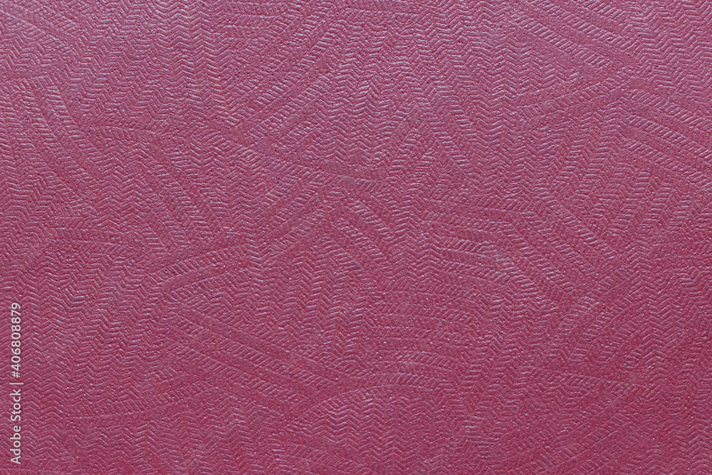 Fototapeta premium The surface of the red old worn dermatin with a small pattern.