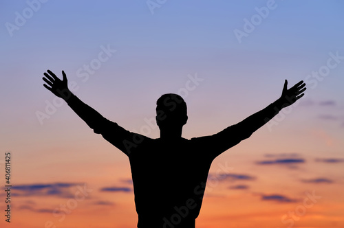 Men silhouette at sunset, human body over natural colorful sky background, hands up having fun © Ryzhkov Oleksandr