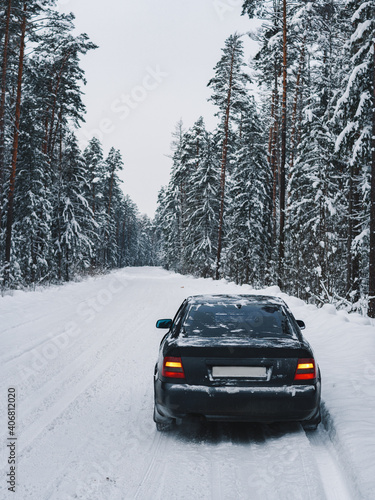 Car on winter snow road in coniferous forest © pavelkant