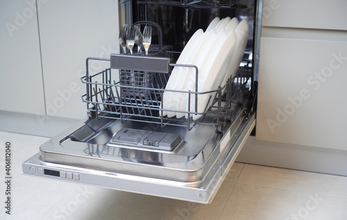 Photos Open integrated dishwaher machine in a modern kitchen
