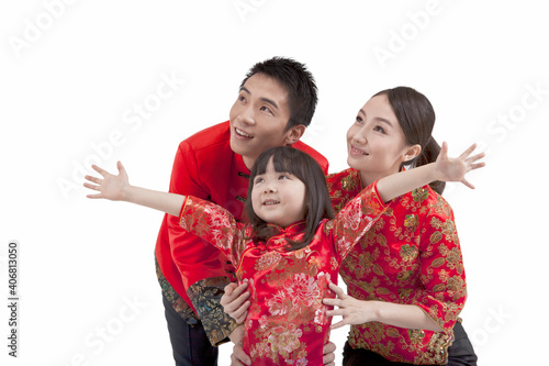 Portrait of daughter opening arms with parents behind  photo