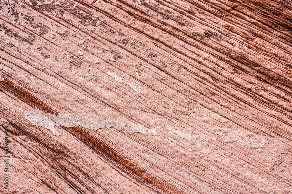 Pink, sandstone rock texture with a pattern of irregular diagonal layers shaped by aeolian processes. Pink, sandstone rock texture with a pattern of irregular diagonal layers shaped by aeolian processes.