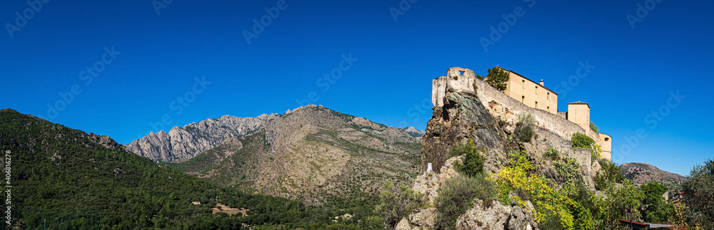 The mountains Punta di Zurmulu, Capo Nero, Punta Finosa, Capizzolo and the citadel of Corte, Corsica, France.