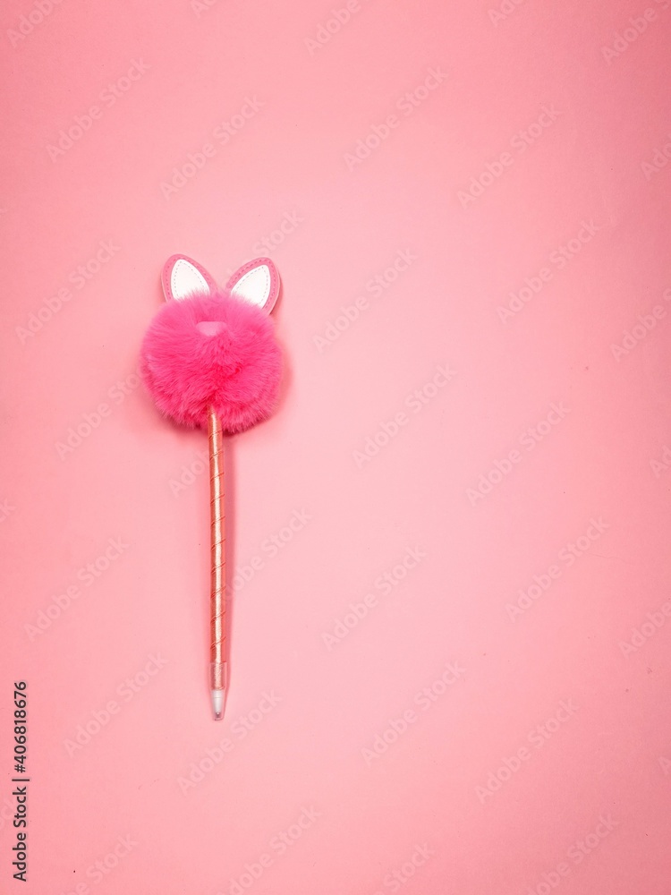 Pink fluffy rabbit in the form of a pompom and a pen on a pink background. Creative rabbit pompom with cute ears. copy space . Easter Bunny rabbit Pink fluffy rabbit in the form of a pompom and a pen on a pink background. Creative rabbit pompom with cute ears. copy space . Easter Bunny rabbit
