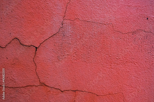 Rough textured red wall with stains, selective focus