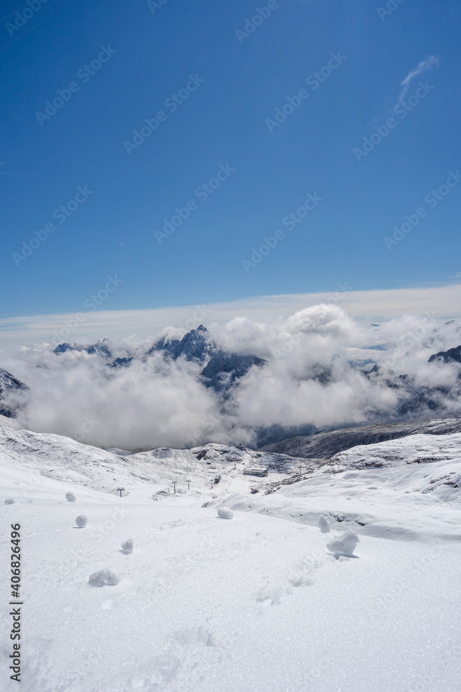 Snowy slope below Zugspitze Top of Germany in summer sunny blue sky