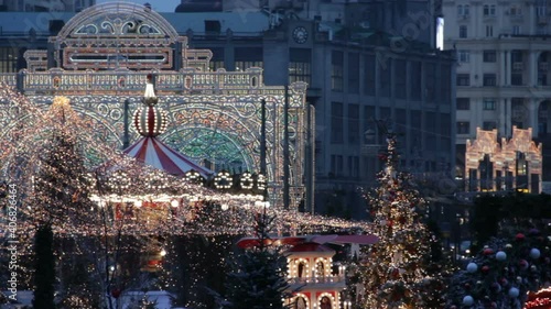 Big carousel on the Red Square in Moscow.Christmas market and decorations in the city.Big christmas tree illuminated gates on Manezhnaya Square.Tverskaya street on background