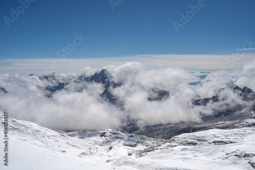 Snowy slope below Zugspitze Top of Germany in summer sunny blue sky