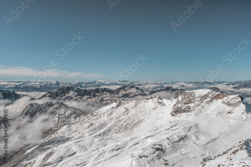 Snowy white Alpine mountain range in summer time on Zugspitze, top of Germany