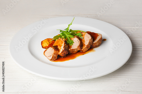 Juicy piece of grilled meat with fried potatoes and arugula