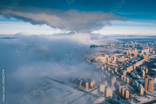 Moscow on a frosty winter day under the  blanket  of steam from the pipes of thermal stations.
