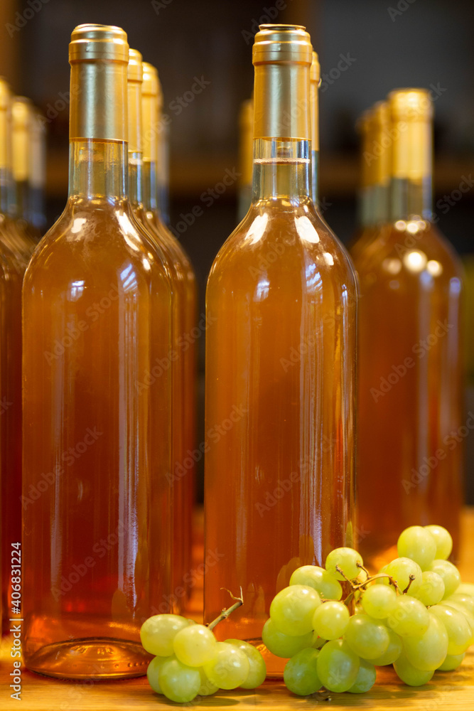 A few bottles of white wine with grapes. A few bottles of white wine with grapes.