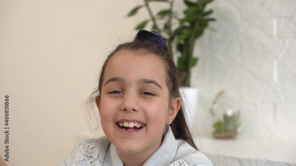 Little girl takes off her protective medical mask and smiles. Stay home mom. Coronavirus or COVID-19. Cute little girl in a protective mask