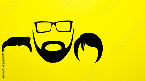 Faces of a father with a daughter and a son, made with silhouettes. Cenital shot with copy space. Father's day concept