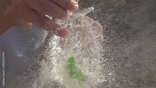 Water balloon exploding on wooden boards. Water explosion in slow motion