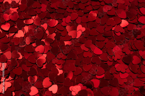 background made from little glittering heart confeti, copy space valentines day concept.