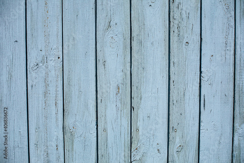 Stock photo of a painted wooden textured background of a shed. Light blue wooden planks.