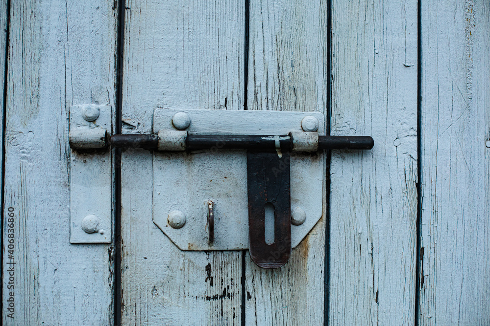 A wooden fence, a door. White vertical boards A wooden fence, a door. White vertical boards
