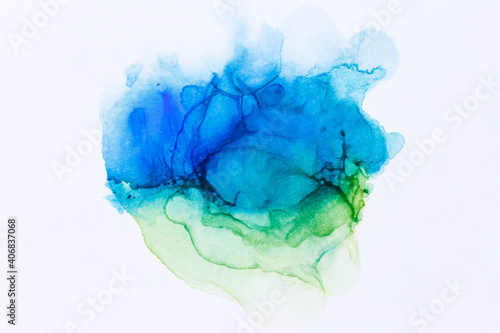 Close-up of abstract blue and green alcohol ink texture on white. Fluid ink, colorful textured background. Vibrant colors. Art for design.