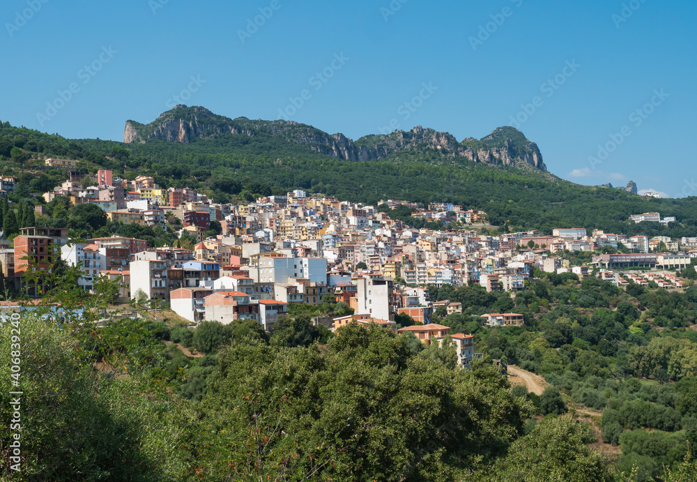 Cityscape of old pictoresque colorful village Jerzu with limestone rocks, mountains and green forest vegetation. Summer sunny day. Province of Nuoro, Sardinia, Italy, Europe