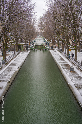 Paris, France - 01 16 2021: View of a Canal of the Basin of the villette under the snow