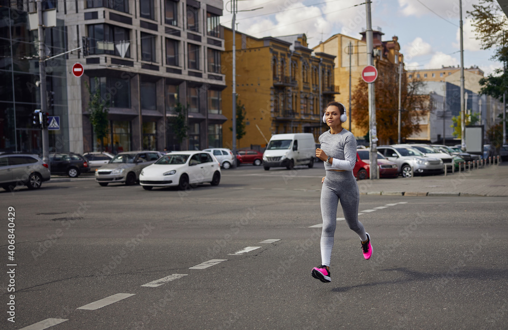 Beautiful healthy cheerful smily woman workout in an urban city street