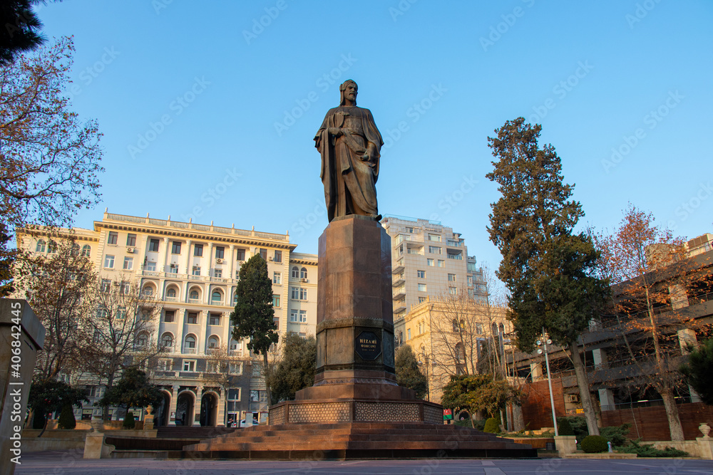 Fototapeta premium Baku, Azerbaijan - January 2, 2021 - View of Neoclassic Monolith residential building and Nizami Ganjavi Monument in Baku.