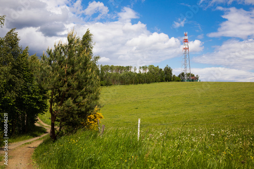 Communication tower - transmitter and lookout tower in meadows.