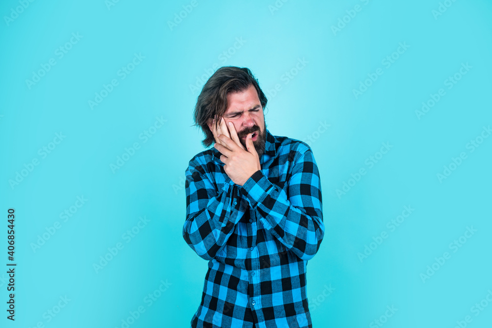 unhappy handsome hipster has toothache. mature man has moustache. feel the pain. bearded man in checkered shirt. brutal guy with emotional face unhappy handsome hipster has toothache. mature man has moustache. feel the pain. bearded man in checkered shirt. brutal guy with emotional face