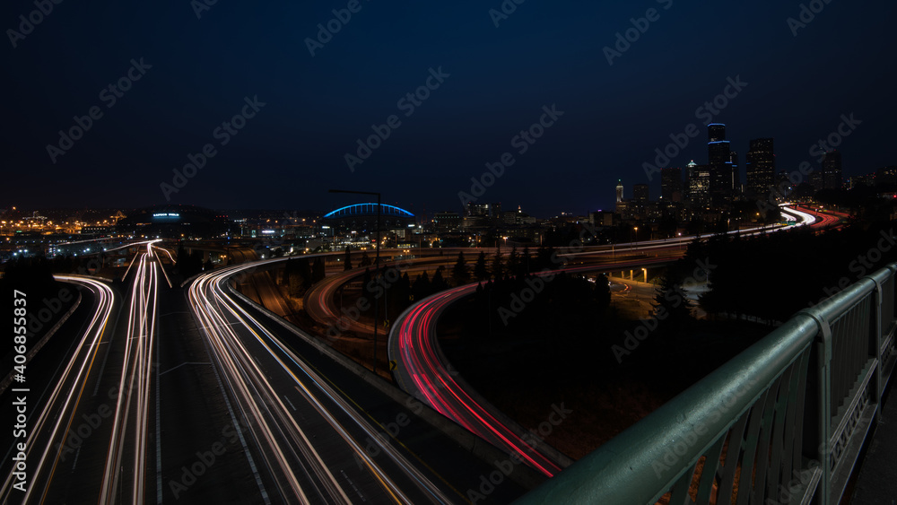 Seattle cityscape at night from the Jose Rizal Bridge, with car trails.