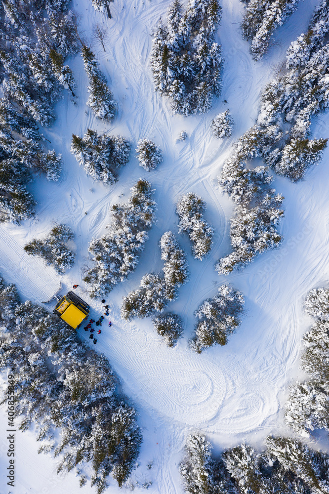 Aerial drone photo of a group of skiers and snowboarders in a snow cat in the Chic Choc Mountains of Quebec, Canada