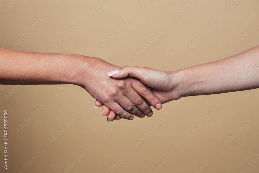 handshake. two hands on a beige background handshake. two hands on a beige background