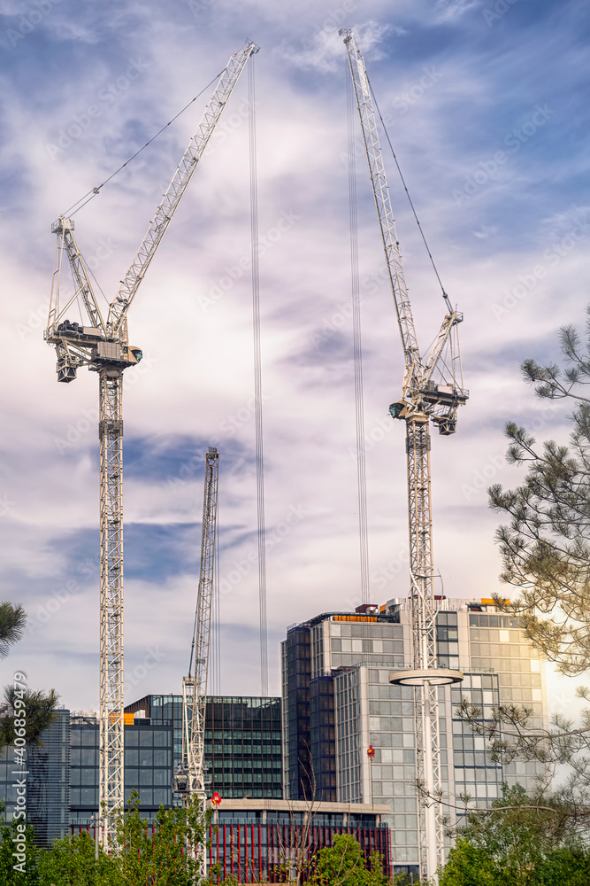 Construction site with large cranes towering into the sky Construction site with large cranes towering into the sky