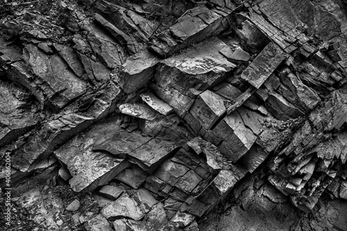 Texture, background layers and cracks in sedimentary rock on cliff face. Cliff of rock mountain. Rock slate in the mountain. Seamless abstract background. Cracks and layers of sandstone.
 photo