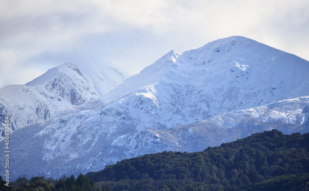 Fototapeta premium snowy mountains with forest