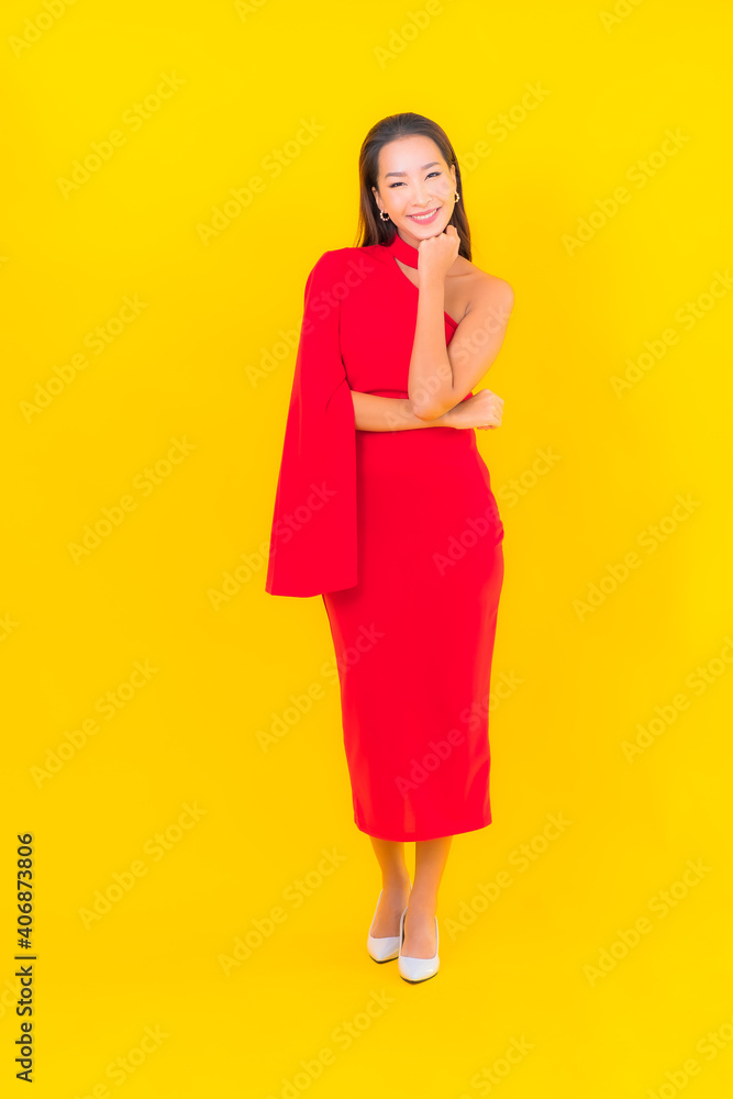 Portrait beautiful young asian woman smile with action on yellow background Portrait beautiful young asian woman smile with action on yellow background