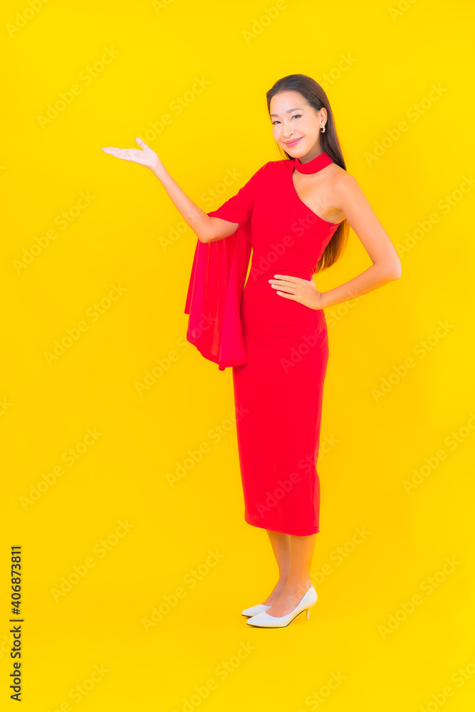 Portrait beautiful young asian woman smile with action on yellow background Portrait beautiful young asian woman smile with action on yellow background