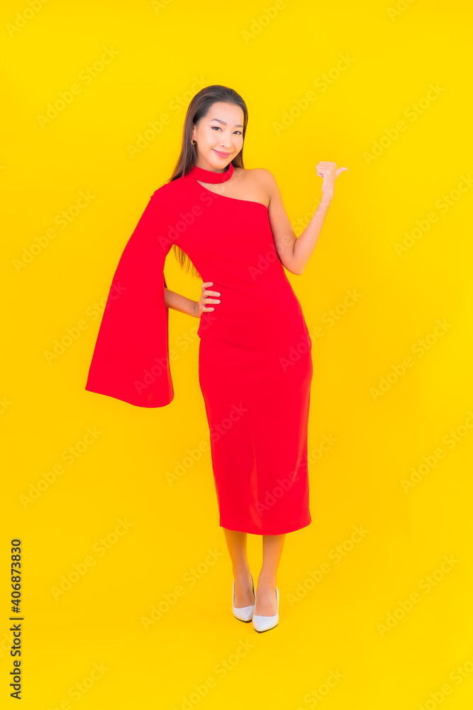 Portrait beautiful young asian woman smile with action on yellow background Portrait beautiful young asian woman smile with action on yellow background
