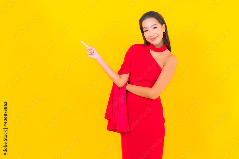Portrait beautiful young asian woman smile with action on yellow background Portrait beautiful young asian woman smile with action on yellow background