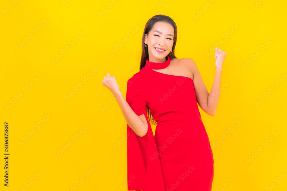 Portrait beautiful young asian woman smile with action on yellow background Portrait beautiful young asian woman smile with action on yellow background