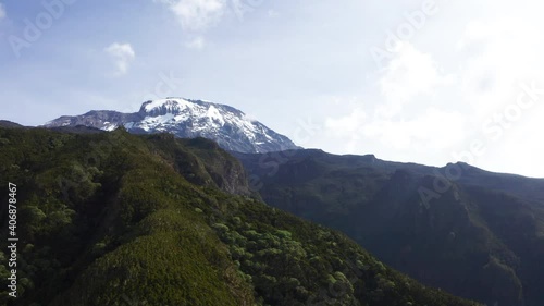 4K aerial footage of a highest African continent summit - Kilimanjaro Uhuru Peak 5895m volcano covered with snows. Drone point of view flying up at cca 3600m. Umbwe route, Tanzanian National Park photo