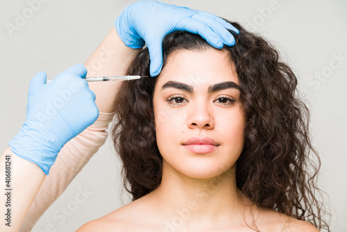 Good-looking woman getting a lifting procedure