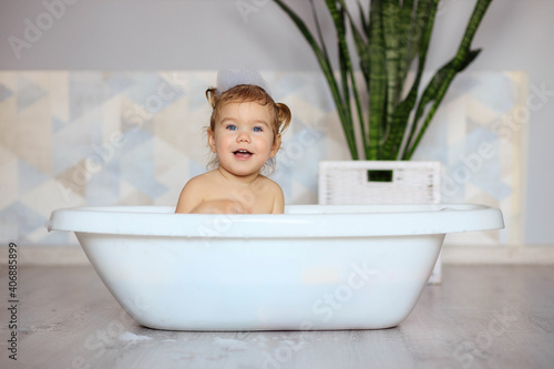 happy baby bathes in the bathroom